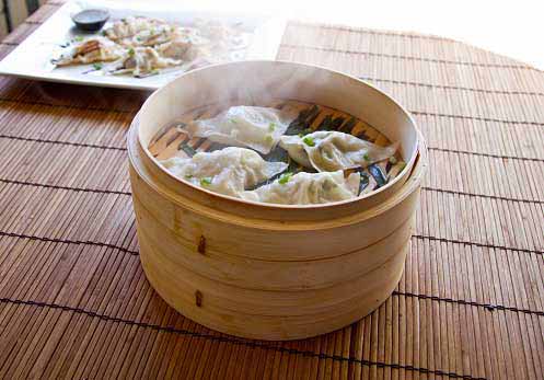 healthy vegetable dimsums being cooked in a steamer